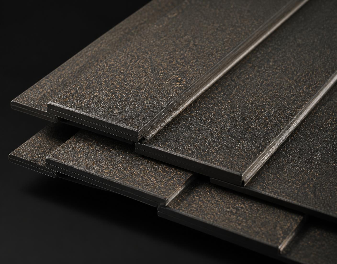 Close-up of overlapping dark charcoal Lithos composite roofing tiles